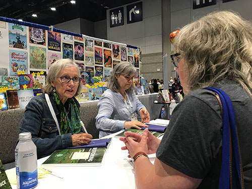 Laurie Lawlor signing books at Holiday House booth at ALA Conference 2023